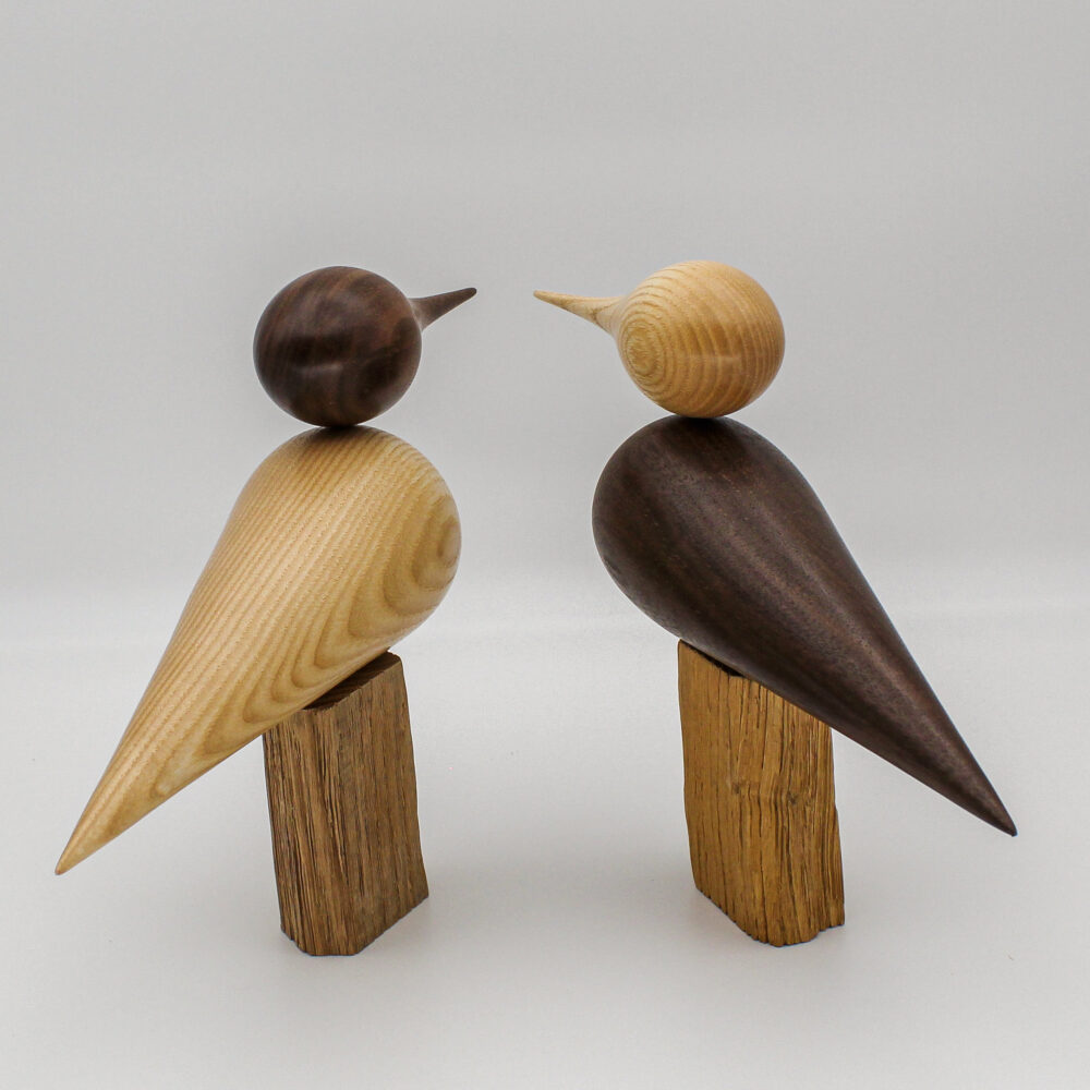 deux oiseaux en bois de frêne et bois de noyer cote à cote vue de derrière